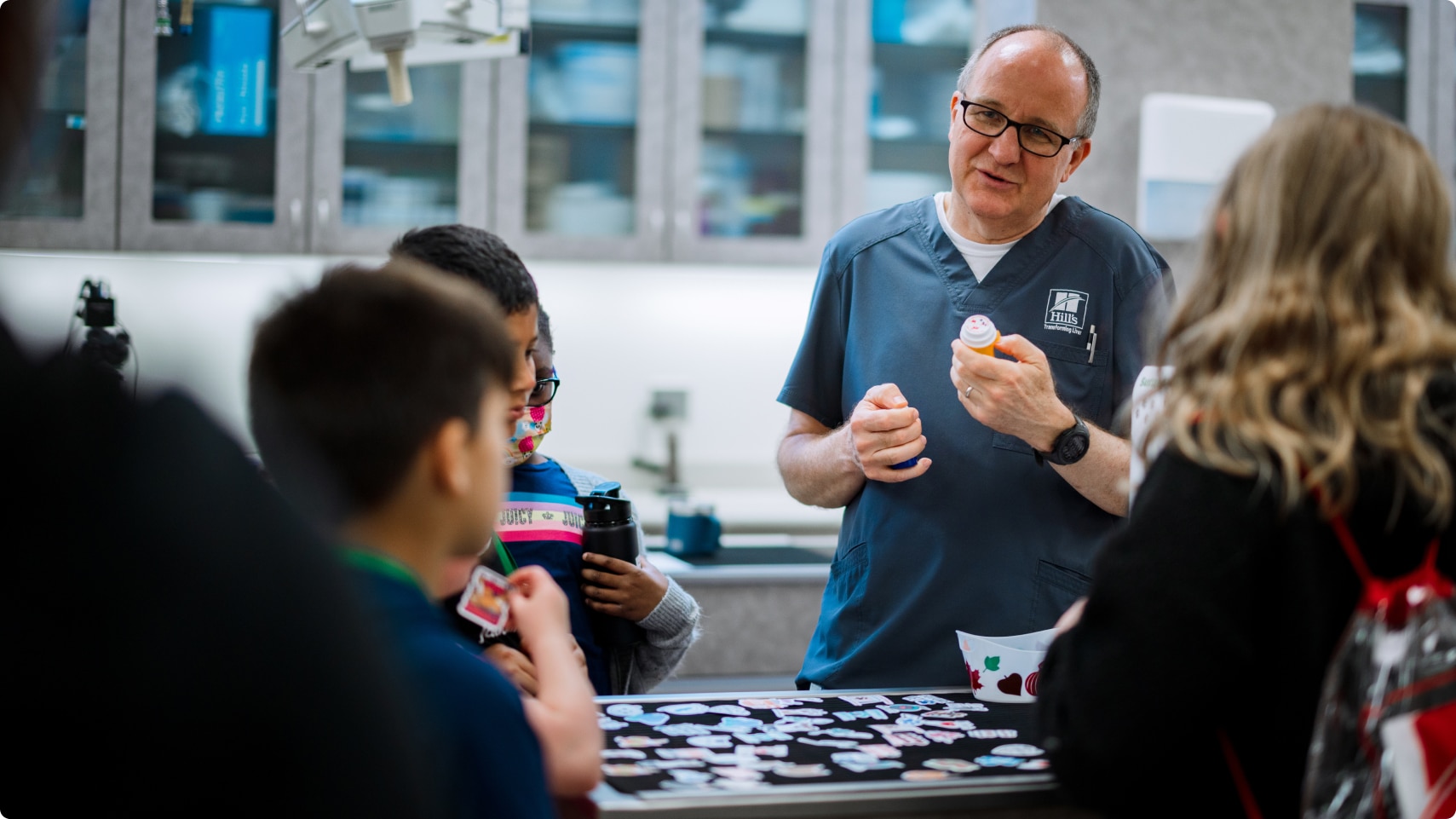 A Hill’s employee playing an educational game with children inside the lab